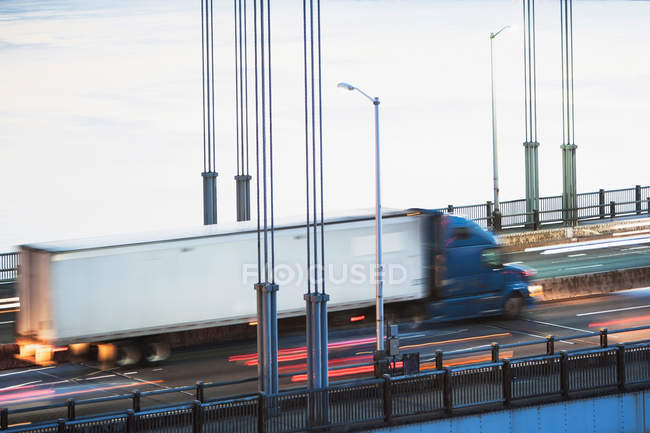 Container truck crossing bridge — Stock Photo