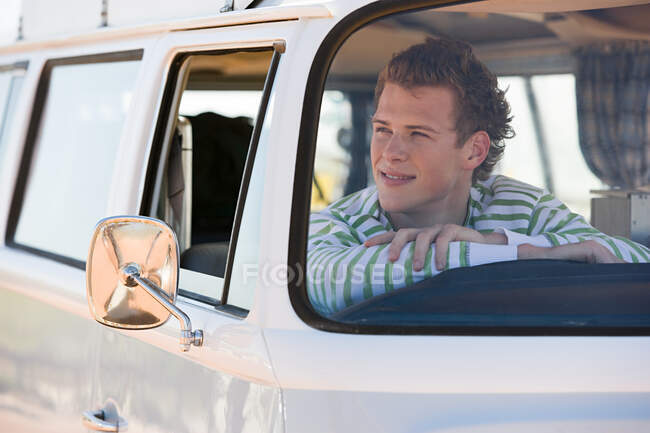 A young man in a camper van — Stock Photo