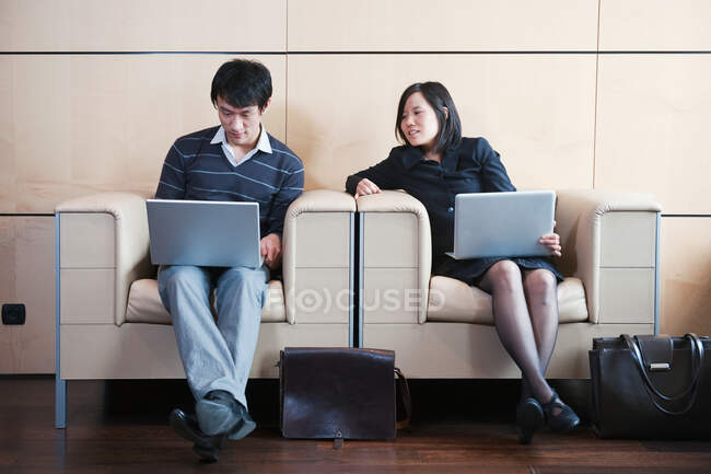 Man, woman working while waiting — Stock Photo