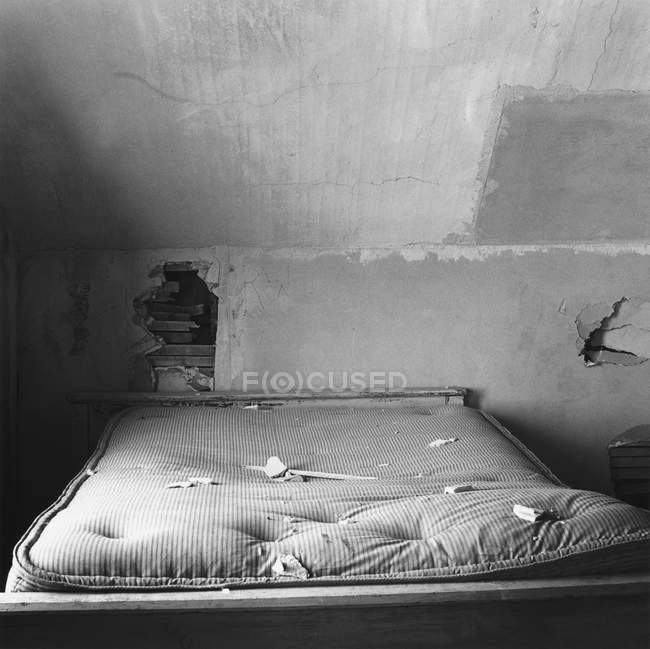 Dilapidated bedroom, black and white image — Stock Photo