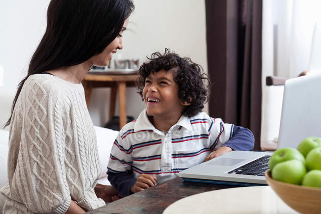 Mutter und Sohn benutzen Laptop im Wohnzimmer — Stockfoto