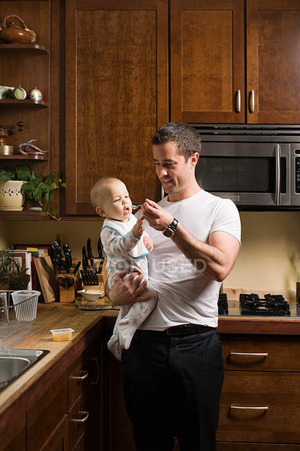 A father feeding his baby — Stock Photo