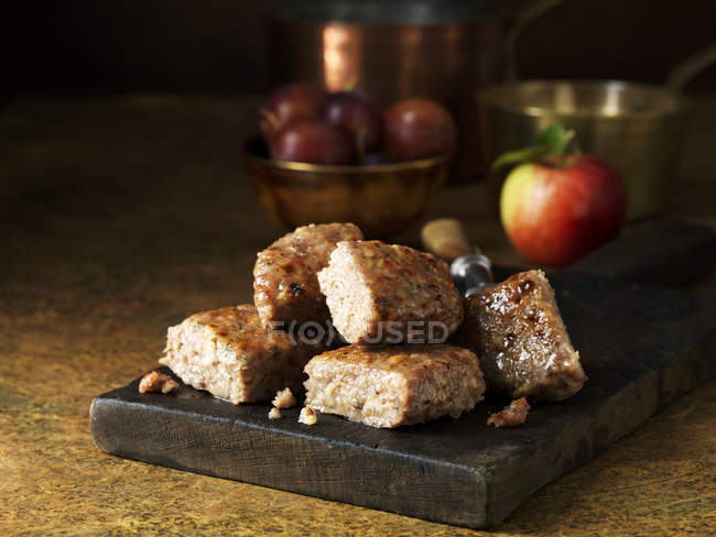 Roasted pork on rustic chopping board — Stock Photo