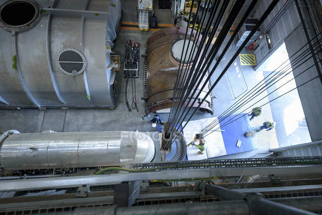 Engineers crane steam turbine parts during outage in gas-fired power station — Stock Photo