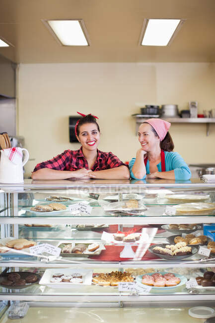 Deux femmes debout au comptoir de la boulangerie — Photo de stock
