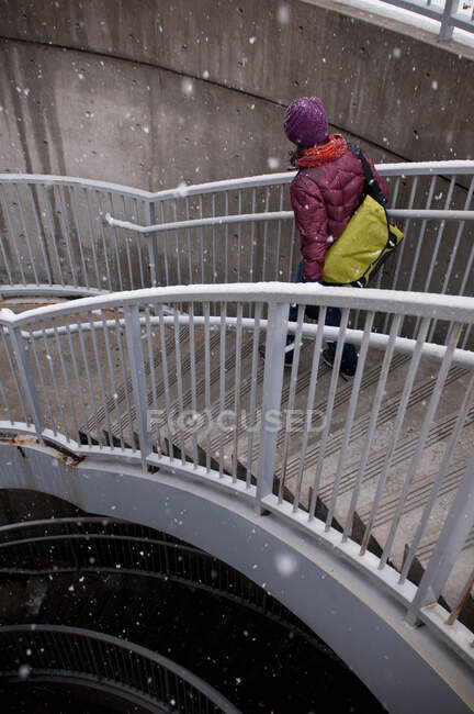 Woman climbing staircase in snow — Stock Photo