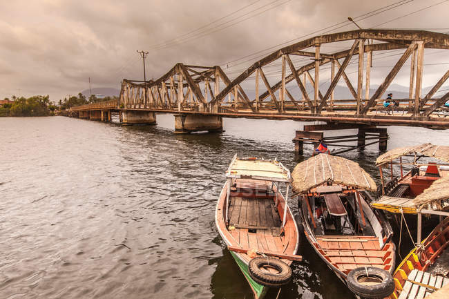 Due barche ormeggiate sul molo vicino al vecchio ponte — Foto stock