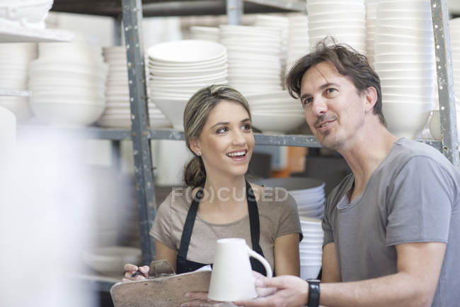 Potters chatting at crockery factory — Stock Photo