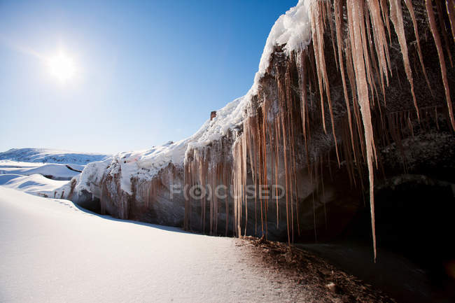 View of frozen icicicles against blue sky, greenland — стоковое фото