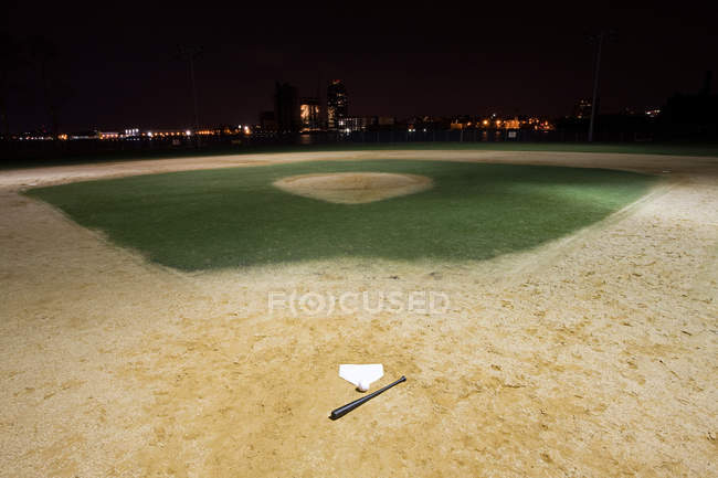 Campo de beisebol vazio iluminado à noite — Fotografia de Stock