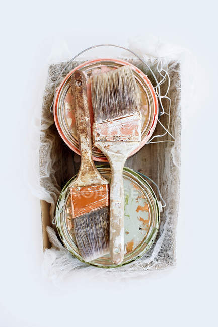 Paint brushes and tins — Stock Photo