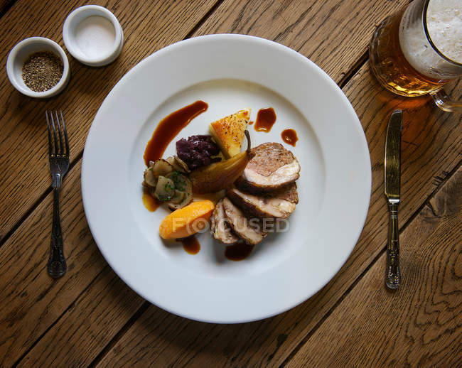 Stuffed pork with pears on plate — Stock Photo