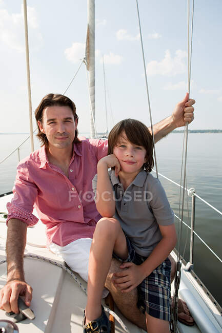 Father and son on board yacht, portrait — Stock Photo