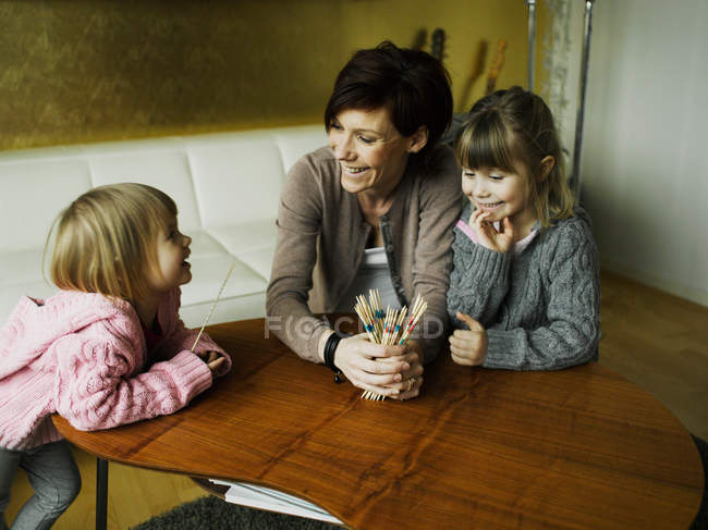 Mother and daughters playing together — Stock Photo