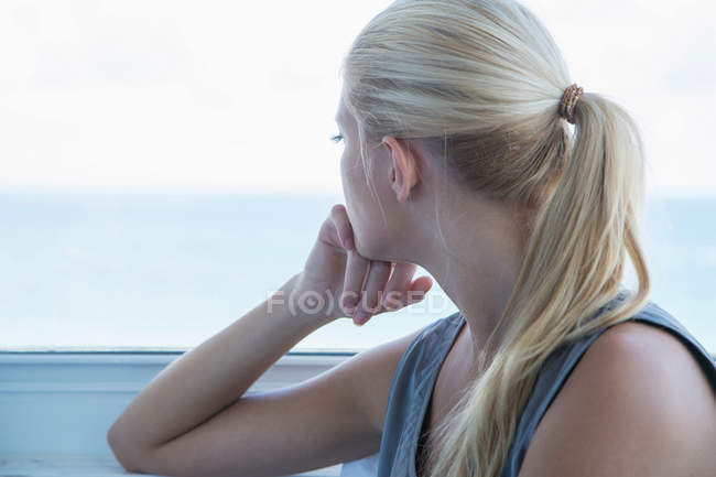 Portrait of Woman looking out window — Stock Photo