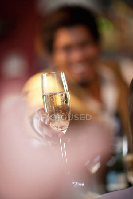 Bartender offering champagne at bar — Stock Photo