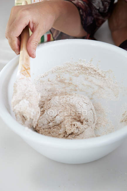 Boy stirring dough in bowl — Stock Photo