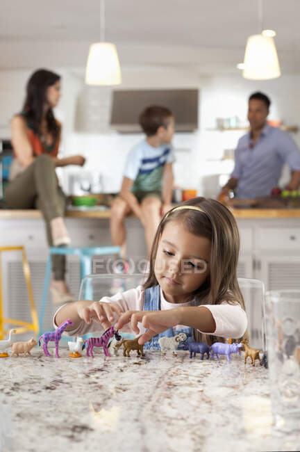 Girl playing with toy animals — Stock Photo