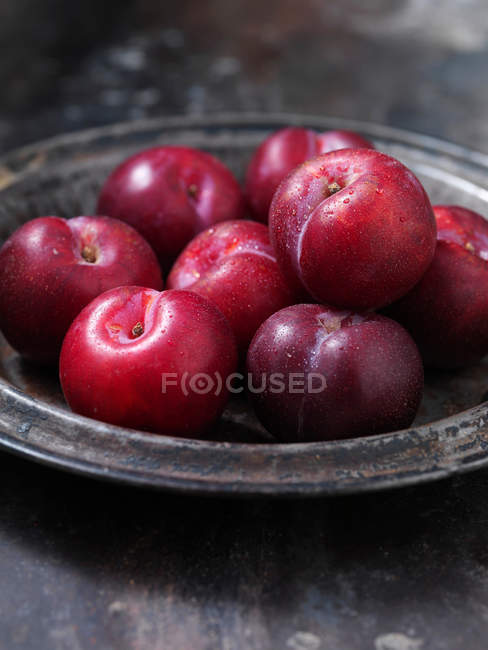 Gros plan du bol de prunes mûres fraîches cueillies — Photo de stock
