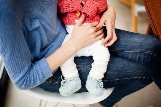 Mother holding newborn daughter, cropped image — Stock Photo