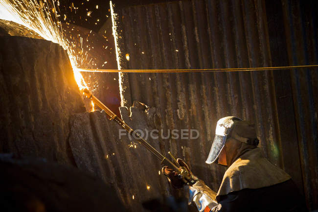 Welder at work in steel forge — Stock Photo