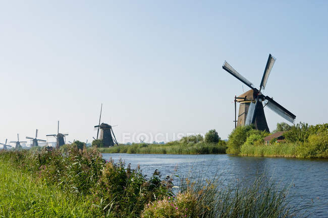 Windmills in row on shore — Stock Photo