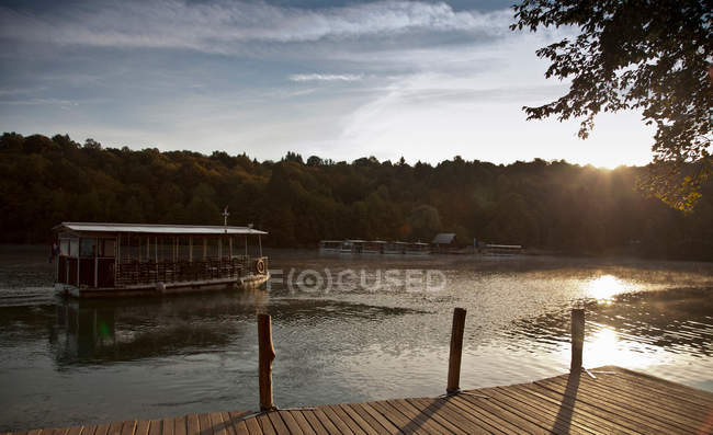 Ferryboat sailing on still lake — Stock Photo