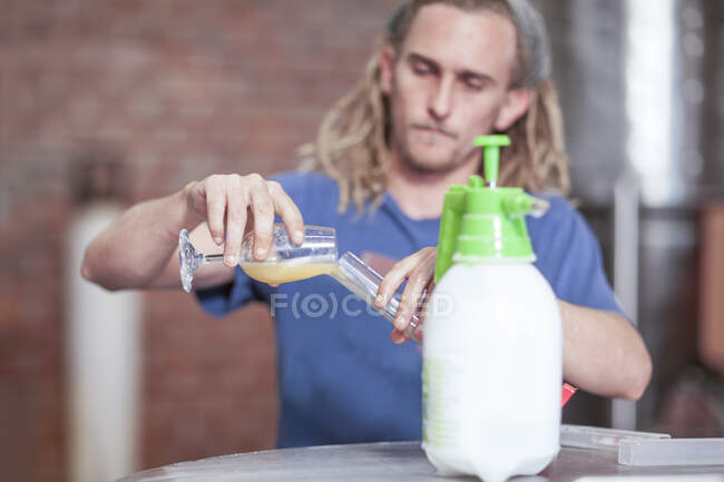 Cape Town, South Africa, young male pouring beer in glass — Stock Photo