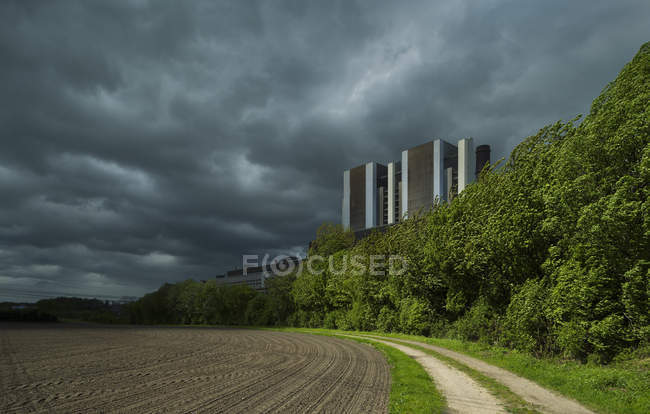 View of brown coal fired power station and storm clouds — Stock Photo