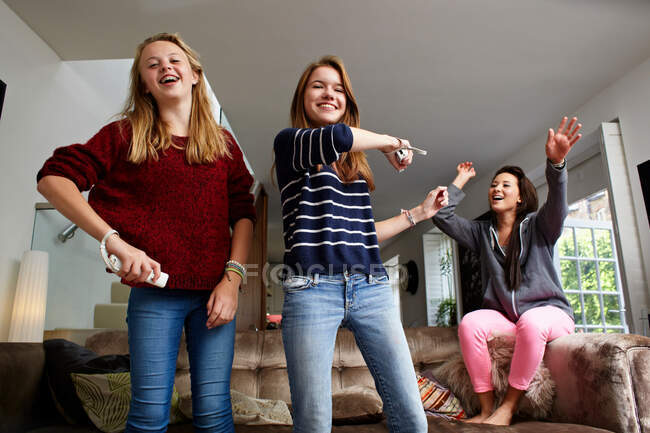 Teenage girls playing video game — Stock Photo