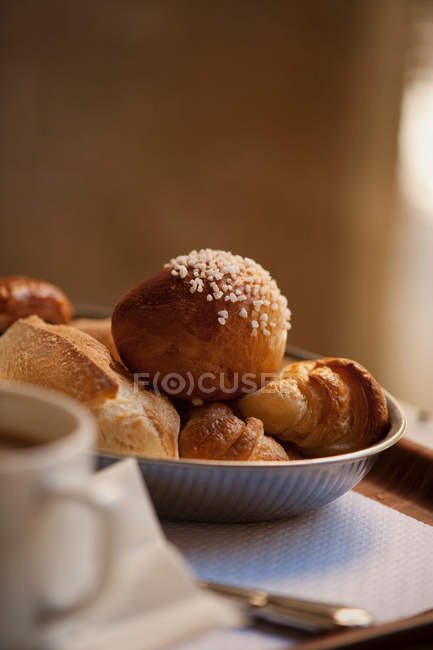 Bowl of breakfast pastries on table, close up shot — Stock Photo