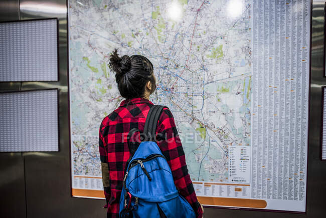 Mid adult woman looking at street map, Milan, Italy — Stock Photo