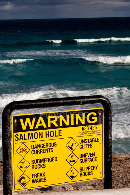 Primer plano del cartel de advertencia en la playa . - foto de stock
