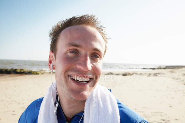 Happy man on beach after exercise — Stock Photo