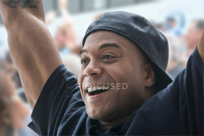 Man at sports game with arms raised — Stock Photo