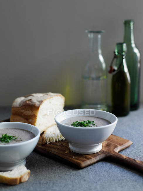 Bowls of soup with bread — Stock Photo