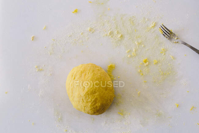 Pasta dough, fork on white chopping board — Stock Photo