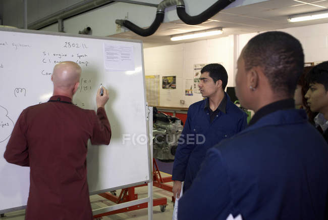 Mechanics teacher writing on board, selective focus — Stock Photo