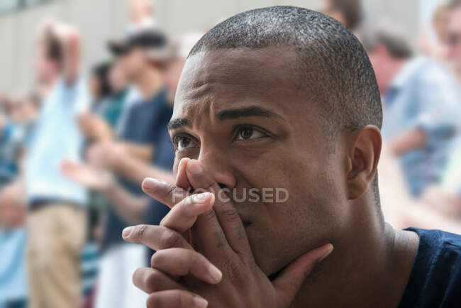 Tense man at sports game — Stock Photo