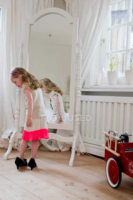Girl wearing mothers high heels — Stock Photo