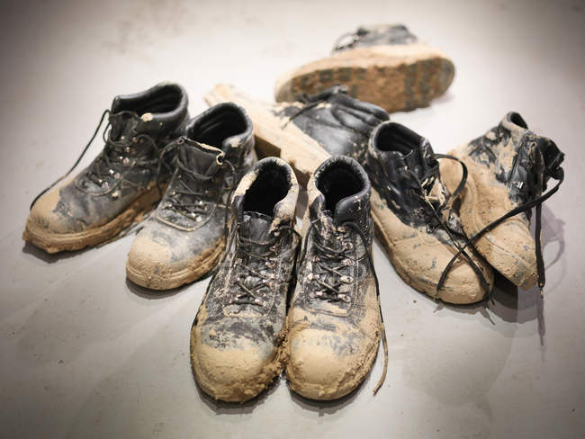 Soiled boots of workmen from a quarry — Stock Photo