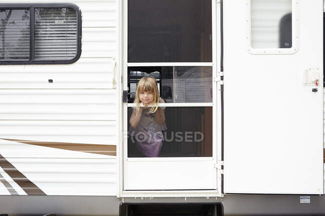 Retrato de niña en la puerta de la caravana - foto de stock