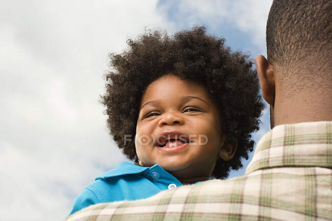 Baby being carried by father — Stock Photo