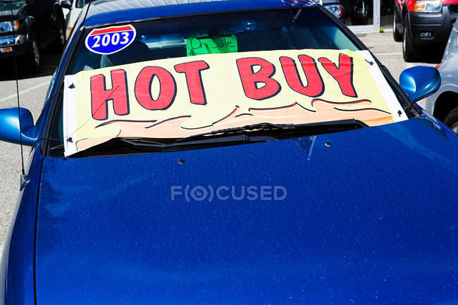 Автомобіль зі знаком продажу гаряче купити на вітровому склі — стокове фото