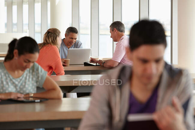 Mature students using laptop — Stock Photo