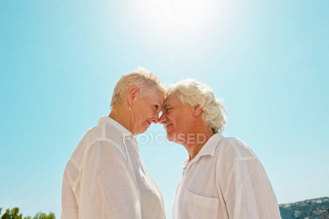 Older couple touching noses outdoors — Stock Photo