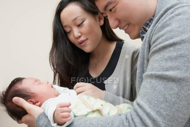 Parents holding sleeping baby — Stock Photo