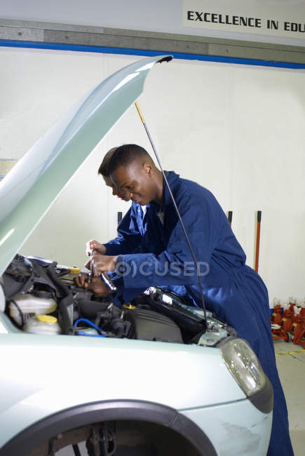 Student working on car engine, selective focus — Stock Photo