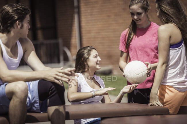 High school volleyball students team talking outside high school — Stock Photo