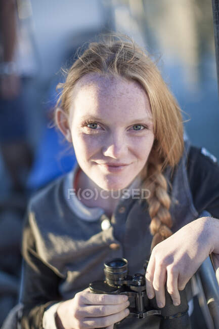 Cape Town, South Africa, young girl smiling with binocualrs in hand — Stock Photo